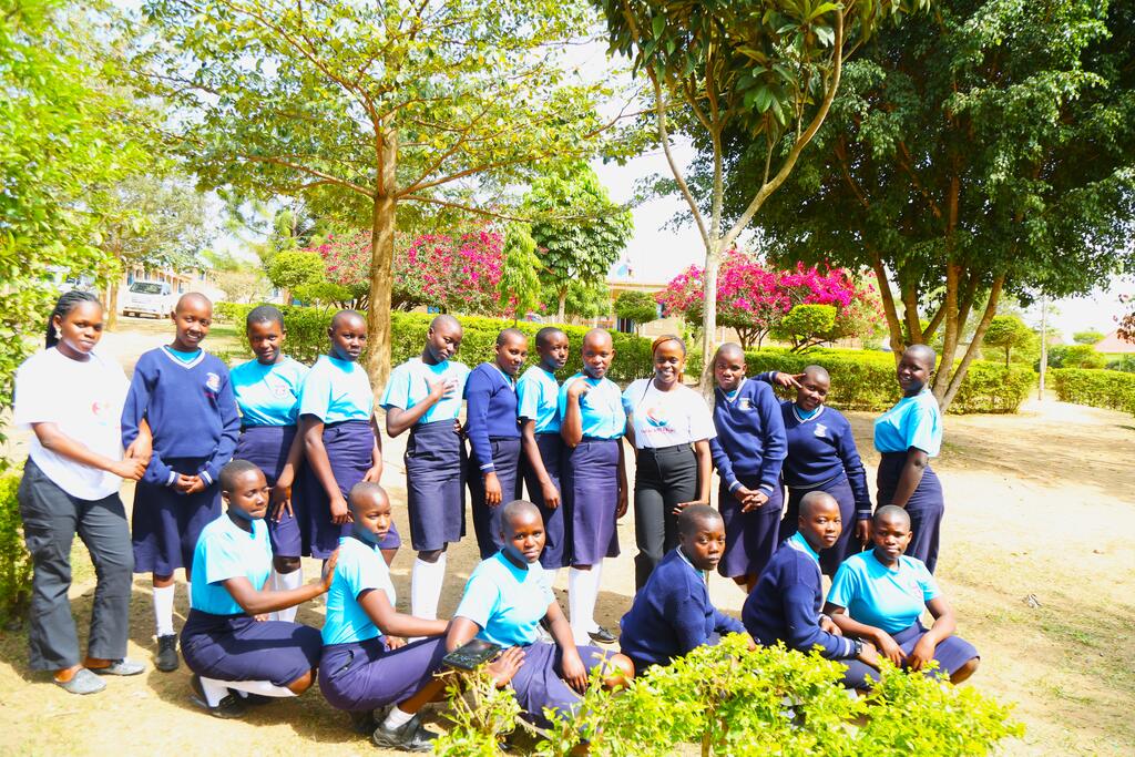 Secondary school students in uniform gathered in their school garden